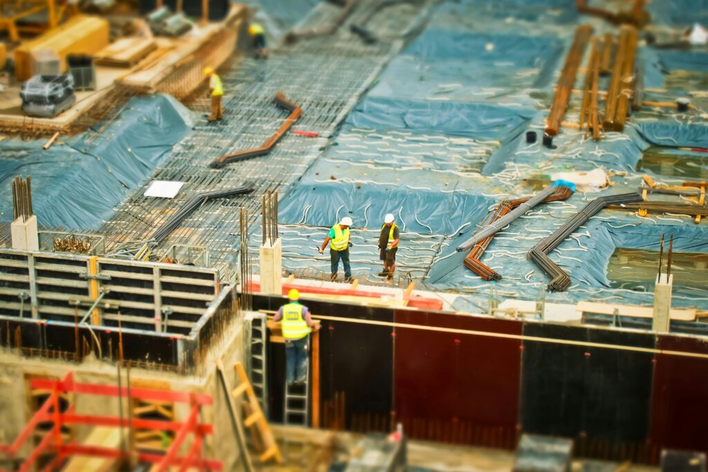 construction-site-build-construction-work-159358-159358 High-angle view of construction workers on a building site, engaging in construction work.